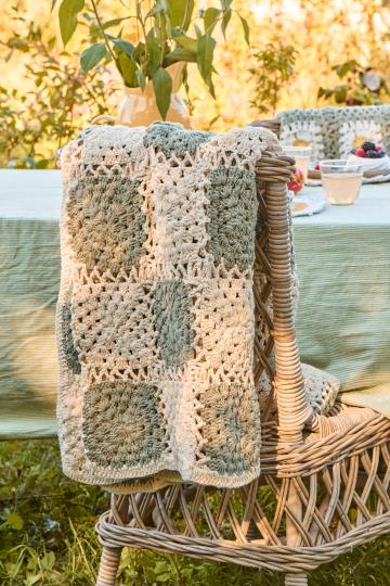 Cream crochet blanket with green squares