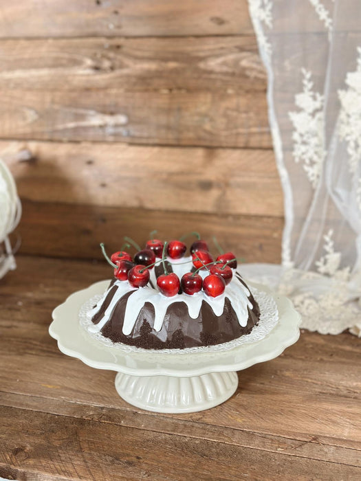 Artificial cherry and icing donut