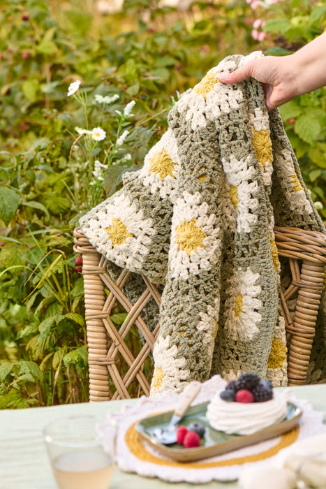 Dusty green crochet blanket with white and yellow flowers Ib Laursen